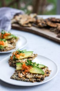 Light and crisp, these Rustic Seed Crackers are keto, gluten-free and vegan.  This recipe is incredibly easy, flexible, adaptable and full of toasty rich flavor.  They are the perfect snack by themselves, and pair with most toppings. #ketocrackers #keto #crackers #seededcrakers #seedcrackers