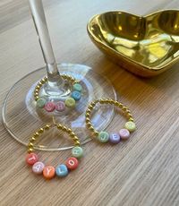 These beaded wine charms are adorable! 💕 Planning my wedding and thinking these would make the cutest bridesmaids' gifts ever! Each one personalized with their names – such a thoughtful touch! Can't wait to add these to my wedding party goodies!