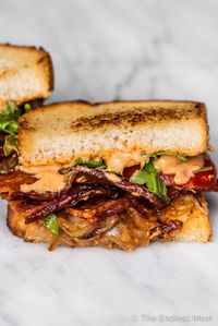 If you're looking for the best bacon sandwich, look no further. Lightly pan-toasted bread, crispy slices of bacon, sweet caramelized onions, smoky chipotle mayo, thin slices of tomatoes, and a little arugula come together to make one irresistible sandwich. #theendlessmeal #baconsandwich #sandwich #sandwiches #bacon #sandwichrecipes #baconrecipes #caramelizedonions #bestsandwich