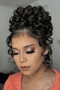 This fancy updo has lots of shiny, neatly shaped curls piled high on top of the head to make a big and nice style. Small strands gently surround the face, making the look softer and adding a bit of romance. This hairstyle works for many things, good for proms, weddings, or any special event where you want to stand out. - Click to see more of 27 Stunning Updos That Will Take Your Breath Away and follow us for more hairstyle ideas. // Photo Credit: Instagram @mariasandovalmakeupartist