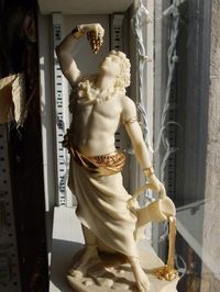 Dionysus  God of wine, celebrations and ecstasy. Patron god of the art of theatre. . Son of Zeus and the mortal Theban princess Semele. Married to the Cretan princess Ariadne. The youngest Olympian, as well as the only one to have a mortal mother.