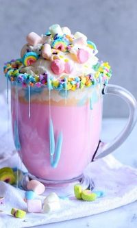 Unicorn Hot Chocolate-A magical pastel rainbow of color, fluffy mini marshmallows and a warm and creamy white chocolate make this Unicorn Hot Chocolate the stuff of little girls' dreams. This quick and easy recipe would make a great surprise beverage for a cold winter day or a tasty sweet treat for a special birthday party or celebration. It's the perfect warm drink dessert for a sleep over slumber party.