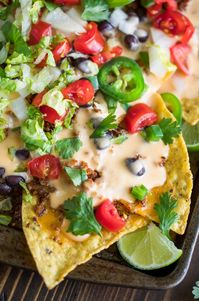 Bring on the queso! These Easy Sheet Pan Nachos are topped with a speedy homemade queso and ready for faceplantage! Even better? They are totally customizable with both vegetarian and T-Rex versions!