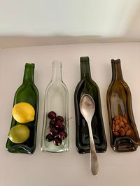 You will be the talk of the party with this classy up-cycled serving tray. Choose the color you like and bring on the snacks! Make your wine loving friends envious of this bottle turned decorative serving tray. This tray is slumped with a slight curve. These make great gifts and are perfect for dinner parties. What a fun way to serve your fruit, snacks, candy and (bonus) it makes a great spoon rest too! Choose from green, clear, dark green or amber colored glass.