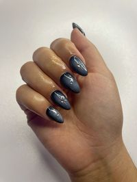 black nails with white airbrush and chrome stars