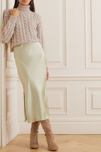 Style Brunello Cucinelli's slip skirt with the brand's luxurious knitwear. Cut from satin in a hushed shade of ivory, it has a fluid drape and sits high on your waist. The split along one side reveals skin in such a sultry way.