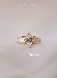 14K Yellow Gold | Chelsey features a bold lozenge cut center stone with a graceful tapered shank featuring straight channel set baguettes.