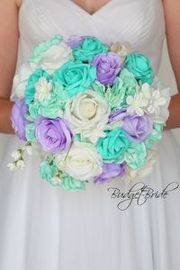 This stunning brides bouquet is hand held bouquet with a mixture of lavender, white and spa roses accented with spa hydrangea and white filler. This bouquet is approx 12 inches wide