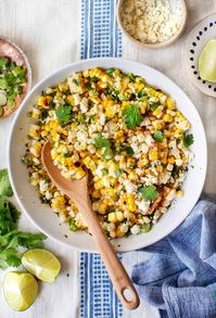 This 10-ingredient Mexican Street Corn Salad is the ultimate summer cookout side! Grilled corn is tossed in a lightly creamy mayo/lime dressing, while scallions, Cotija cheese, paprika, and jalapeño add spicy, fresh pops of flavor. So easy and delicious! | Love and Lemons #corn #salad #sidedish #grillingrecipes