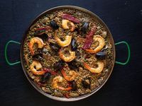 A delightful twist on a Valencian paella, this paella recipe features chicken, shrimp, and mussels. Paprika and chorizo add a smoky, spicy kick.