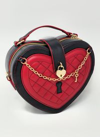 To all Queens out there, this one is for you! Queen of Hearts is a medium sized vampy and edgy heart bag which matches well with many coords, including gothic lolita style and punk alternative outfits. It combines red and black in a tasteful way which gives space to a lovely quilted surface which is soft to the touch, the most adorable heart and key accessories, crown zipper pulls, and easily opens by way of metallic button! The bag is conveniently and simply opened by zipper and has a metallic