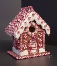 Elevate your indoor holiday decor with our exquisite Handmade Christmas Gingerbread Birdhouse crafted from durable polymer clay. Meticulously shaped and textured by hand, this charming piece features realistic icing patterns on gingerbread walls and a snowy roof dusted with seasonal magic. Perfect for adding a touch of whimsy to your festive setting, please note that it is designed for indoor display only and is non-functional for birds. Embrace the spirit of the holidays with this carefully crafted polymer clay masterpiece, bringing joy and sweetness to your seasonal celebrations.