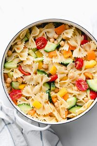 Chickpea + Vegetable Pasta Salad features fresh chopped colored bell peppers, refreshing cucumber, juicy cherry tomatoes and protein rich chickpeas for a quick and healthy cold pasta salad! Ready in 30 minutes! Vegan, vegetarian, clean eating, plant based recipe!