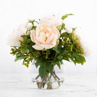 This gorgeous real touch peony flower arrangement includes 5 light pink peony flowers with peony flower buds and a splash of green berries. Handcrafted for lasting beauty, this real touch silk flower arrangement is the perfect elegant centerpiece arrangement for a dining room table, living room, coffee table, or classy foyer. #peonyarrangment #tablearrangement #peonycenterpiece #luxuryhomedecor #interiordesign