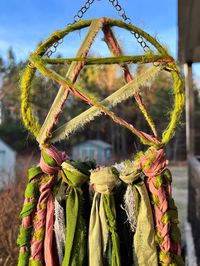 One of a kind wall decor handmade with upcycled silk and chiffon, featuring mossy shades of green and muted pinks. 5 inch mossy pentacle hoop with an antique brass chain. Approximately 29 inches long from top of the hoop.