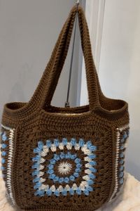 Handmade crochet granny square large shoulder bag Approximately measures 13" H. 16" W. Strap length is 19". Fully lined. Made from 100% acrylic yarn.