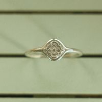 A dainty signet-style ring featuring a raised pattern inspired by mosaic tiles. Perfect for any finger but particularly lovely on a pinky finger. Solid Sterling Silver