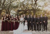 Fall wedding inspiration for your bridal party, burgundy bridesmaids dresses, and charcoal gray groomsman suits with blush and burgundy bouquets and boutonniers by luxury wedding florist, The Sentimental Petal in Baton Rouge Louisiana. Photograph by Lauren Cavalli copyright 2022