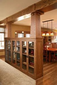 Bookcase built in with craftsman pillars to keep it open to the next room!