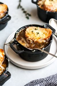 An incredible, classic French onion soup recipe made with delicious caramelized onions, fresh herbs, and a flavorful broth. Top this wonderful French onion soup with gruyere cheese and a toasted slice of garlic French bread. You'll make this one again and again!