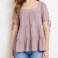 This Is A Lovely Maurices Babydoll Short Sleeved Top. Tiered With Crochet Separation Lines And A Tie At The Back Of The Neck To Support The Wider Square Neckline. Color Is A Lovely Dusty Lavender. Very Comfortable And Feminine Fit. New With Tags. Women's Size Medium I Have Multiple Maurices Tops In My Closet! Make A Bundle For A Great Discount! Laying Flat Measurements: Pit-To-Pit 20.5" Top To Bottom 24"