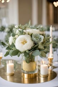 Sage green, gold and white flower wedding table centre piece ✨   #sagegreen #sagegreenwedding #sagegreenandgold #wedding #weddingcentrepiece #weddingplanningtips #weddingreception #weddingseason #weddingtablecenterpieces #weddingtablescapes