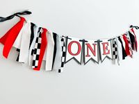 "This red, black, white and pale blue fast one themed \"ONE\" banner will be the perfect addition to your little one's first birthday! This banner will look great hanging anywhere during your child's birthday party, but the size was chosen specifically to fit on a high chair (shown in 5th pic).  Each pennant is 4x6. The banner is strung on black satin ribbon. All letters will be upper case.  There are ten strips of fabric on either end of the banner. The strips are 1.5 inches wide and hang approximately 6-7 inches.    Leave the date that you need the banner in the \"Notes to Seller\" section during checkout.  Coordinating Decorations https://www.etsy.com/shop/declanandsmith?ref=seller-platform-mcnav&section_id=23011307 --->Shipping Addresses: Please ensure that you select the correct addre