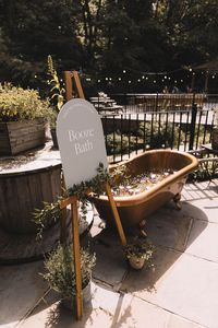 Booze bath wedding drinks station with neutral wedding signage on easel next to the bath | wedding drinks | wedding drink serving ideas | Lauren Elliott Weddings