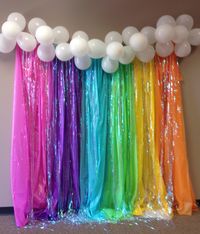 Back drop using plastic table cloths, iridescent door streamers and balloons for clouds