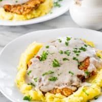 This Chicken Fried Steak is perfectly seasoned with a crispy coating and a mouthwateringly juicy and tender interior. Fried to golden perfection and topped with a homemade gravy. #chickenfriedsteak #countryfriedsteak #recipe