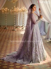 Embellished Kameez with Bridal Sharara Dress is an epitome of elegance and tradition. This breathtaking Pakistani Bridal Dress is beautifully embellished with intricate embroidery work and floral jaal. The premium quality fabric of this masterpiece makes this attire a perfect choice for the gorgeous Bride. Kameez: Bridal Kameez in the lilac shade has a luxurious net fabric, This heavily embellished shirt is a glamorous choice to wear at the wedding. This front open kameez is intricately adorned