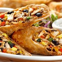 Baked eggrolls with a Southwest twist, chicken, onion, beans, corn, spinach, and jack cheese are rolled in tortillas and served with salsa or your favorite sauce for dipping.