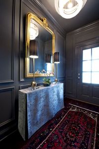 Glamor rises in this room. With walls painted in rich, dark Perle Noire SW 9154, gold and silver accents shine, while the oriental rug adds a hint of color and texture.