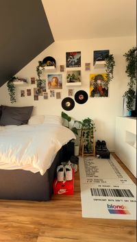 Step into nostalgia with this vintage-inspired bedroom adorned with a retro rug, iconic album cover posters, vinyl record wall art, and charming fake vine plants! 🎶✨ Shop all the decor pieces featured in this image by clicking the link. #VintageVibes #MusicLovers #HomeDecorGoals