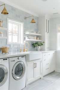 coastal laundry room with light blue subway tiles and white farmhouse sink