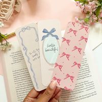 Bow Coquette Bookmark Set | Perfect for book lovers, add a lil coquette flair to your books, notebooks, planners, Bibles and more. Embrace your inner girly girl. These bookmarks would make for a great bookish gift or be the cutest book accessories. Details: -Dimensions: approx. 2" x 6" -Glossy UV Coated Finish (front side only) -Double Sided design -14pt thick bookmark Designs: -Print Pink Bows  -Hello Beautiful Mirror -To all the books I ever read Choose From 3 Options: - Individual, Surprise S