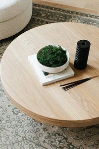 A white oak coffee table brings an organic feel to the interior design of a library in Denver Colorado