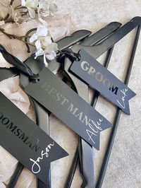 My Groomsmen Hanger tags are handmade to order and personalised as you wish with a variety of names & roles.  They are made using matte black acrylic, premium quality vinyl & black satin ribbon. The perfect addition to your hangers to remind you of who's suit is who's!  Size - aprox 15 x 5cm  My groomsmen hanger tags are handmade to order and take 5-10 business days to dispatch.  If you require your Grooms gift sooner, please pop me a message and I will do my best to help.  If you like my best m