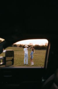 Experience the captivating love story of a western couple in a country field at sunset in Tulsa, Oklahoma. This enchanting photoshoot highlights their deep connection through storytelling and romantic poses.