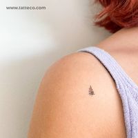 Tiny pine tree temporary tattoo placed on the shoulder.