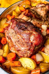 This pork roast recipe is a whole meal in one, with juicy citrus-seasoned pork shoulder slow-roasted with carrots, potatoes, and fresh herbs. #porkroast #porkshoulder #roast