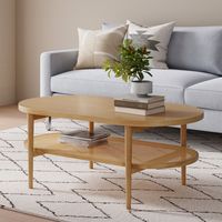 Beachcrest Home Le minimalisme scandinave rencontre le style classique dans cette table basse à 2 niveaux. Fabriqué à partir de bois massif et d'ingénierie, il présente un design épuré avec une finition brun clair naturel qui s'intègre parfaitement dans des styles qui favorisent les éléments organiques et les neutres vifs. Un plateau de table ovale reflète un deuxième niveau, tous deux soutenus par des pieds en forme de goujon de style H. La sangle de canne tissée crée une surface aérée sur la t