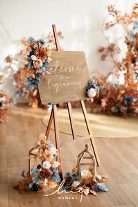 Enhance your wedding décor with Ling's Moment's stunning Wedding Sign Flowers. These delicate blossoms in russet orange and denim blue add an unforgettable touch of elegance to your special day. Perfect for adorning signage, they bring a splash of color and natural beauty to any wedding theme. Indulge in rich hues and romantic floral details in every moment of your wedding journey.