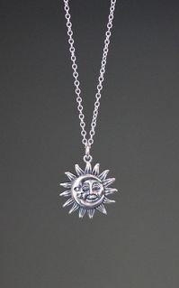 "This beautifully detailed Bali Silver Sun and Moon charm dangles from a silver chain. The chain is adjustable and can be worn close to the neck at 16\" or a little longer at 18\". It is finished with a silver lobster clasp. Please send a message if a longer chain is desired. Wear this necklace by itself or as a layering piece. Coordinating earrings are available... www.etsy.com/listing/1175529018/silver-sun-earrings Silver Sun and Moon pendant: 19mm Total length of charm: 1\" Silver chain: 1.5m