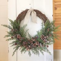 This elegant natural grapevine base wreath contains subtle greenery, snow brushed pinecones clustered in a bed of cedar. Linen knot attached for a simple finish.  Each wreath is handcrafted individually for you upon ordering. Please feel free to contact me with any questions, concerns, or requests.  This wreath will add a classy, clean, and elegant look to your home decor and/or table. Wreaths also make great gifts housewarmings, weddings, birthdays, baby showers, and more!  PLEASE NOTE - All ma