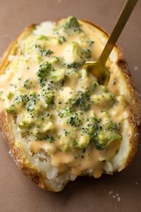 Cheesy Baked Potatoes with Broccoli Cheese Sauce make the most amazing meatless main dish for lunch or dinner and double as a saucy side dish