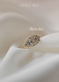 14K Yellow Gold | Benedict features a bold asscher center stone with straight baguette and asscher accent stones set in a bezel setting on a half round flat edge shank.