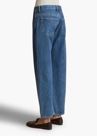 A curved inseam gives this mid-rise, wide-leg jean a flattering and feminine edge. With marigold topstitching and a signature button.