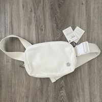 Brand New Lululemon Everywhere Belt Bag/ Fanny Pack Sold Out From Lululemon Color Is White (The Pure White One) Lululemon Logo On Front Is Metal Brand New With Tags Attached Can Be Worn Cross Body Or Around Waist Capacity Is 1l