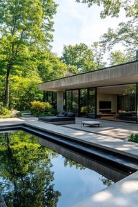 Modern home with large glass windows and a sleek pool. Create your own dream home vision board—a magical space that blends comfort, style, and a splash of whimsy to make everyday living feel like a fairy tale.